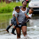 Terrian Jones feels something move in the water as she brings these two boys to their mother during the storm in New Orleans on July 10, 2019.
